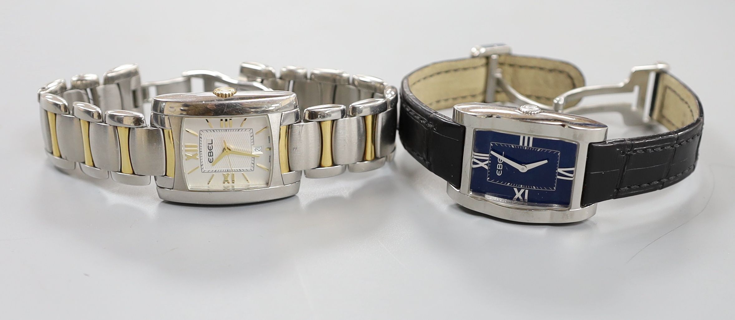 Two modern steel Ebel quartz wrist watches, Tarawa with leather strap and Brasilia with two tone bracelet, both with boxes.